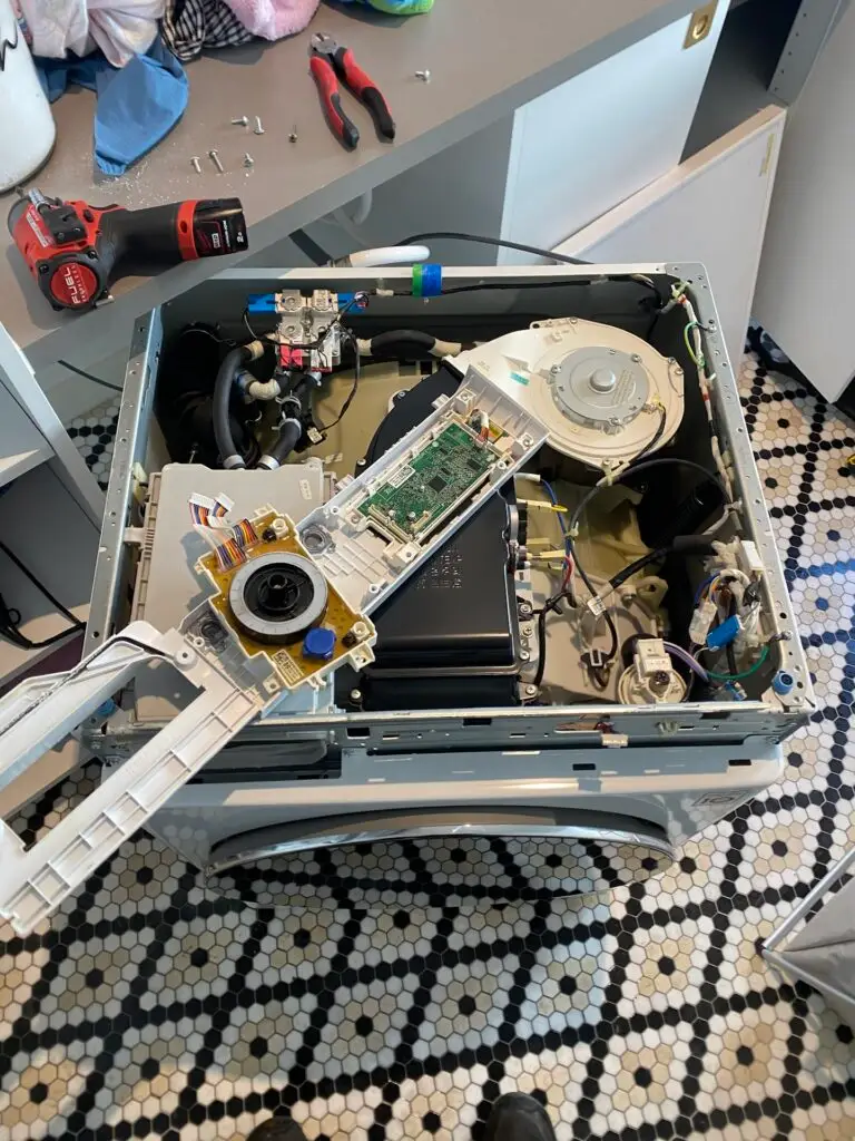 Technician repairing a front-load washing machine in Melbourne